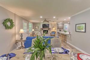 a living room with a blue couch and a table at Updated Home, Less Than 1 Mile to Old Town Bluffton! in Bluffton