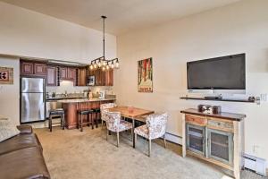 a living room with a dining room table and a tv at Copper Mountain Resort Condo on Golf Course! in Copper Mountain