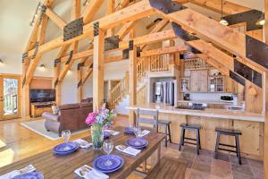 a kitchen and living room with a table and chairs at Scenic Susanville Cabin with Deck on Eagle Lake in Susanville
