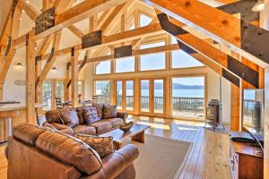 a living room with leather couches and a table at Scenic Susanville Cabin with Deck on Eagle Lake in Susanville