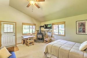 1 dormitorio con cama, escritorio y chimenea en 40-Acre Trego Resort Cabin with Lake and Trails!, en Trego