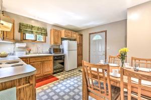 a kitchen with wooden cabinets and a table and chairs at Fishermens Paradise with Fire Pit on Rice Lake! in Rice Lake