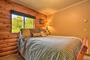 a bedroom with a bed in a room with a window at Gold Beach Apartment with Activities - 2 Mi to Ocean in Gold Beach