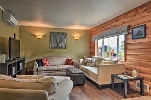 a living room with two couches and a television at Gold Beach Apartment with Activities - 2 Mi to Ocean in Gold Beach