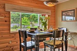 a dining room with a table and chairs and a window at Gold Beach Apartment with Activities - 2 Mi to Ocean in Gold Beach