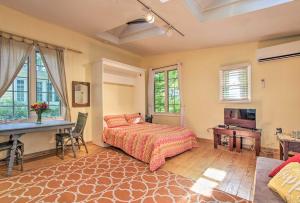 a bedroom with a bed and a desk at Quiet Saugatuck Studio with Patio - Walk to Dtwn! in Saugatuck