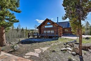 a log cabin in the woods with a yard at 22STR-00019 Fairplay Cabin with Hot Tub and Sauna in Fairplay