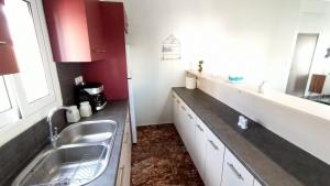 a kitchen with a sink and a counter top at Emerald 110m2 entire floor apt steps to city’s heart in Kalamata +29 photos