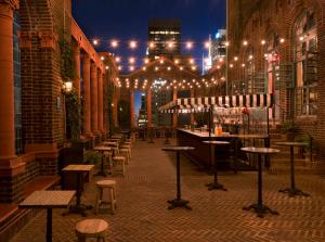 a patio with a bar with lights and stools at Pod 39 in New York