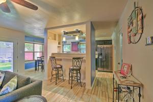 a living room and kitchen with a couch and a bar at San Antonio Oasis with Hot Tub, Pool and Outdoor Bar! in San Antonio