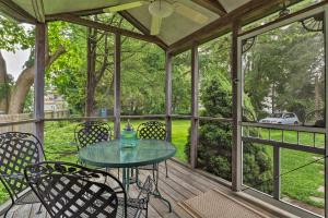 a screened in porch with a table and chairs at Saybrook Manor House, Walk to Cove Beach! in Old Saybrook