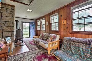 a living room with a couch and a chair at Saybrook Manor House, Walk to Cove Beach! in Old Saybrook