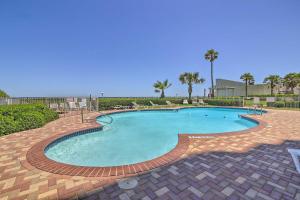 a large swimming pool with a brick pathway around it at Oceanfront Unit with Gulf View by Bayside Attractions in South Padre Island