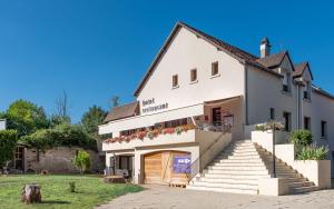 - un bâtiment blanc avec une porte et des escaliers dans l'établissement La Bonne Etape, à Amboise