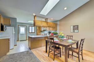 a kitchen and dining room with a table and chairs at Elwood Townhome with Patio - 7 Mi to Johnson Lake in Elwood