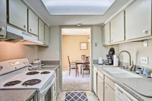 a kitchen with white cabinets and a stove top oven at Destin Townhome with Beach Access & 2 Pools! in Destin