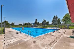 a large swimming pool in a park at Elwood Townhome with Patio - 7 Mi to Johnson Lake in Elwood