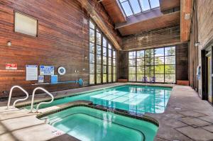 a swimming pool in a building with a large window at Rustic Ski-Out Brian Head Condo with Comm Pool in Brian Head