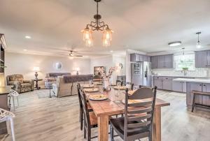 a kitchen and living room with a wooden table and chairs at Waterfront Lake Sinclair Home with Boat Dock! in Milledgeville
