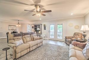a living room with a couch and a ceiling fan at Waterfront Lake Sinclair Home with Boat Dock! in Milledgeville