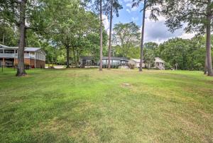 a large yard with a house and trees at Waterfront Lake Sinclair Home with Boat Dock! in Milledgeville