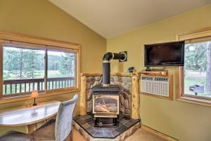 Cette chambre dispose d'une cheminée, d'une table et d'une télévision. dans l'établissement Trego Cabin with Mountain Views and Lake Access!, à Trego