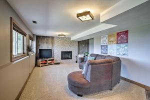 a living room with a couch and a television at Bright, Renovated Apartment with Views of Pikes Peak in Colorado Springs