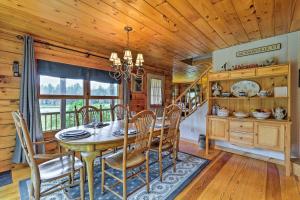 a dining room with a table and chairs at Jacksonville Cabin with Wraparound Deck and Views in Jacksonville