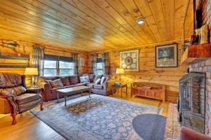 a living room with a couch and a fireplace at Jacksonville Cabin with Wraparound Deck and Views in Jacksonville
