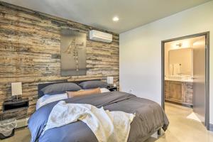 a bedroom with a wooden accent wall with a bed at Elkhart Lake Townhome - 20 Mi to Sheboygan! in Elkhart Lake