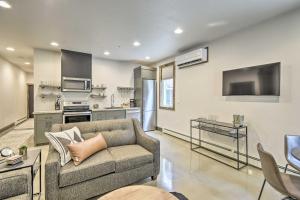 a living room with a couch and a kitchen at Elkhart Lake Townhome - 20 Mi to Sheboygan! in Elkhart Lake