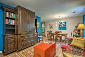 a living room with a large wooden cabinet and a dining room at Renovated Home on Watauga River, By Boat Ramp in Elizabethton