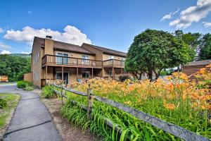 una casa con una valla y un campo de flores en Lincoln Condo with Balcony - 6 Mi to Loon Mtn!, en Lincoln