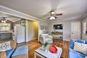 a living room with a couch and a refrigerator at Beaufort Home with Porch, 4 Mi from Downtown! in Beaufort