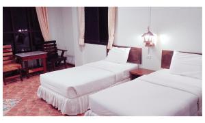 TAWAN RESORT客房内的一张或多张床位