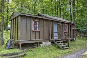 a small wooden cabin in the middle of a forest at Rustic Hayward Cabin With Spider Lake Access! in Seeley