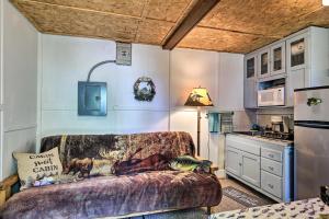 a living room with a couch in a kitchen at Rustic Hayward Cabin With Spider Lake Access! in Seeley