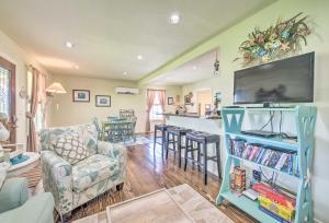 a living room with a couch and a tv at Half-Mi to Seadrift Harbor Seadrift Home with Deck in Seadrift