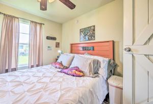 a bedroom with a large white bed with pillows at Half-Mi to Seadrift Harbor Seadrift Home with Deck in Seadrift