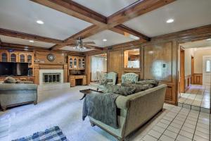 een woonkamer met een bank en een open haard bij Dallas Area Home with Pool - 18 Mi to ATandT Stadium! in Duncanville