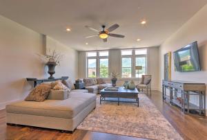 a living room with a couch and a ceiling fan at Modern Main St Apt in Downtown Waynesville! in Waynesville