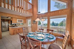 a dining room and kitchen with a table and chairs at Hood Canal Home with Hot Tub - Bordering Olympic NP! in Brinnon
