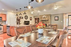 a kitchen and living room with a wooden table and chairs at Home with Community Pool - 2 Miles to The Island! in Pigeon Forge