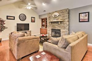 a living room with two couches and a stone fireplace at Home with Community Pool - 2 Miles to The Island! in Pigeon Forge