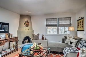 a living room with a couch and a fireplace at Modern Bungalow with Santa Fe Charm Less Than 2 Mi to Plaza in Santa Fe