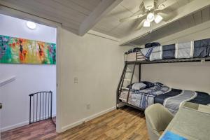 a bedroom with two bunk beds and a ceiling fan at Updated Jamestown Home, Walk to Downtown! in Jamestown