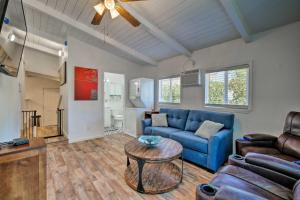 a living room with a blue couch and a table at Updated Jamestown Home, Walk to Downtown! in Jamestown