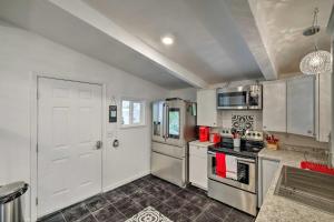 a kitchen with white appliances and a white door at Updated Jamestown Home, Walk to Downtown! in Jamestown