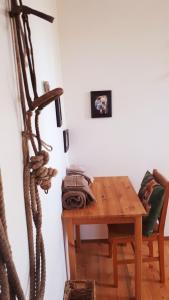 a room with a wooden table with a rope on the wall at Wettstone Guest Ranch in Bridge Lake