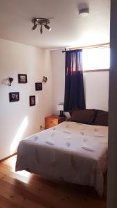 a bedroom with a bed and a window with a ceiling fan at Wettstone Guest Ranch in Bridge Lake